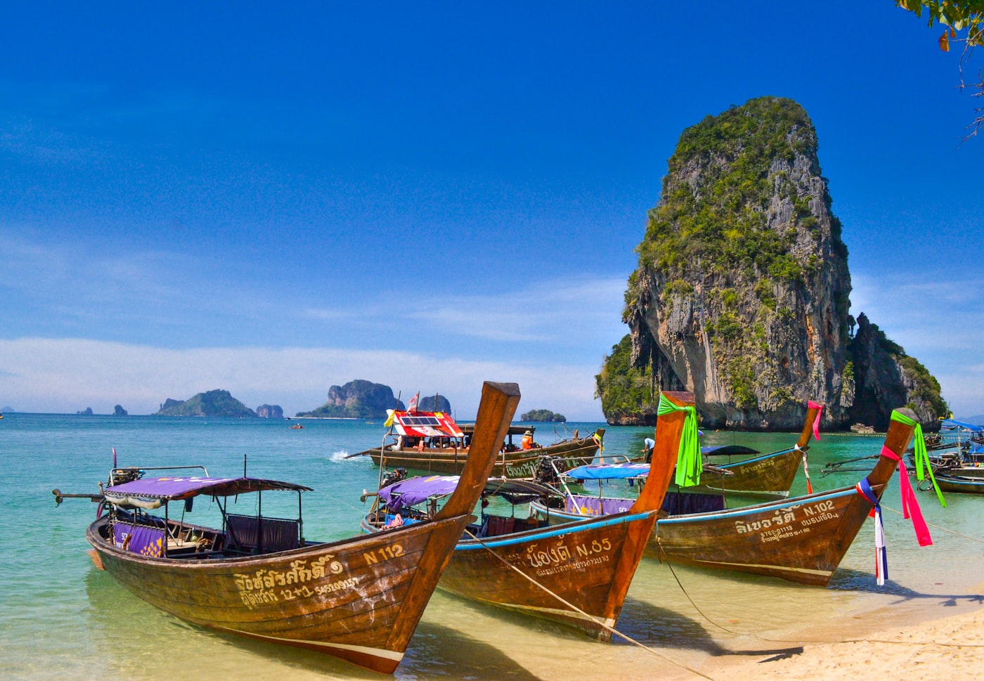 Tropical bay with longtail boats — placeholder photo